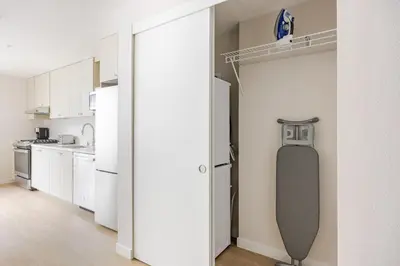 an open door to a kitchen with a skateboard at Blueground Downtown elevator nr parks LAX-1247 in Los Angeles