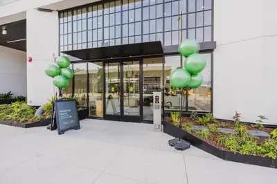 a group of green balloons in front of a building at Blueground Downtown elevator nr parks LAX-1247 in Los Angeles