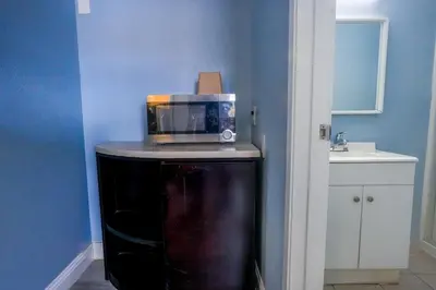 a kitchen with a microwave on top of a refrigerator at Economy Inn Buttonwillow Bakersfield I-5 in Buttonwillow
