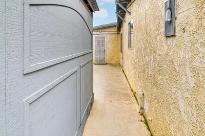 an alley with a gray garage door next to a building at Work, Play and Relax Home with Yard in Lancaster! in Lancaster