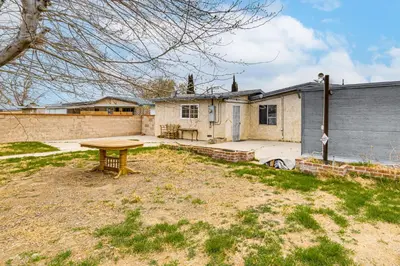 a backyard with a picnic table in front of a house at Work, Play and Relax Home with Yard in Lancaster! in Lancaster