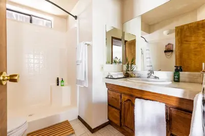 a bathroom with a sink and a tub and a toilet at ADELAIDE HILL IN PINE MOUNTAIN CLUB BREATHTAKING VIEWS 3Bd 3Bth SPA TUB in Pine Mountain Club