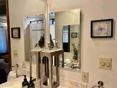 a bathroom with a mirror and a sink at ADELAIDE HILL IN PINE MOUNTAIN CLUB BREATHTAKING VIEWS 3Bd 3Bth SPA TUB in Pine Mountain Club