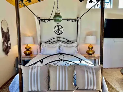 a bedroom with a canopy bed with two lamps at ADELAIDE HILL IN PINE MOUNTAIN CLUB BREATHTAKING VIEWS 3Bd 3Bth SPA TUB in Pine Mountain Club