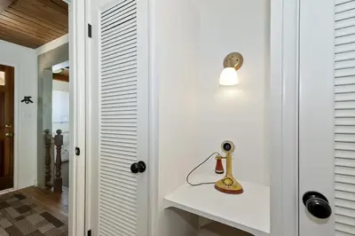 a room with a white wall with a lamp on a shelf at Lake Gregory Skyline Ridge in Crestline