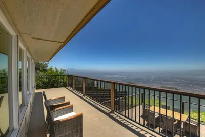 a balcony of a house with benches on it at Lake Gregory Skyline Ridge in Crestline