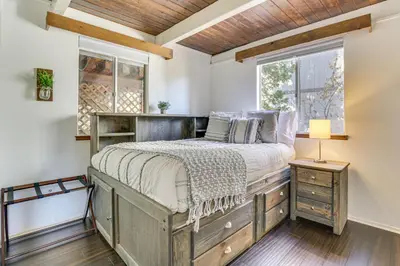 a bedroom with a bed and a window at Family-Friendly Lake Arrowhead Cabin with Game Room! in Lake Arrowhead