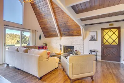 a living room with two couches and a fireplace at Family-Friendly Lake Arrowhead Cabin with Game Room! in Lake Arrowhead