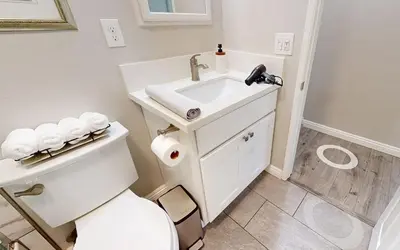 a white bathroom with a sink and a toilet at Modern Oasis for Families & Business, Pets OK, EV in Orange
