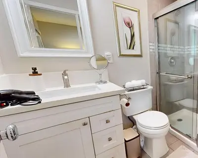 a bathroom with a toilet and a sink and a mirror at Modern Oasis for Families & Business, Pets OK, EV in Orange