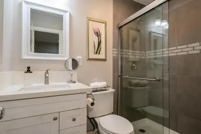 a bathroom with a toilet and a glass shower at Modern Oasis for Families & Business, Pets OK, EV in Orange
