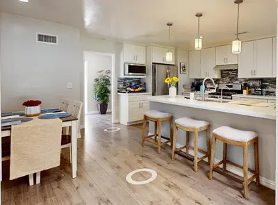 a kitchen with white cabinets and a table and chairs at Modern Oasis for Families & Business, Pets OK, EV in Orange