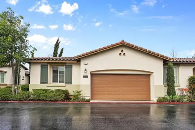 a white house with a brown garage at Gorgeous Family Home, Close to Frwys, Hospitals & Sports Arenas, Pets OK in Orange