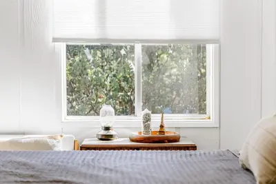 a bedroom with a bed and a window at Luxury A-Frame Retreat in Lake Arrowhead