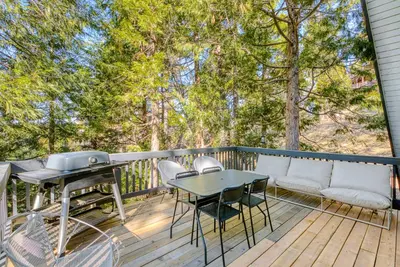 a deck with a grill and a table and chairs at Luxury A-Frame Retreat in Lake Arrowhead