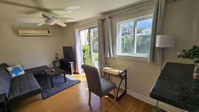 a living room with a couch and a table and a window at Best Prime Location Hollywood Private House in Los Angeles