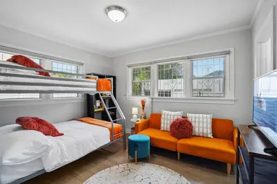 a bedroom with a bunk bed and a couch at Foosball l LA Mural l DTLA l UnivStudios l BevHills in Glendale