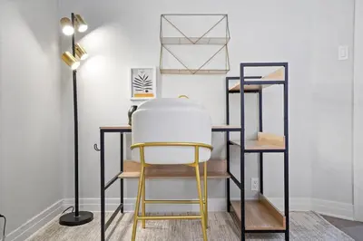 a chair in a room with shelves and a lamp at Foosball l LA Mural l DTLA l UnivStudios l BevHills in Glendale