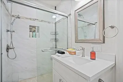 a white bathroom with a sink and a shower at Foosball l LA Mural l DTLA l UnivStudios l BevHills in Glendale