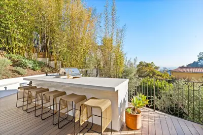 a patio with a bar with stools on a deck at Casa Cortona by Stay Awhile Villas in Los Angeles