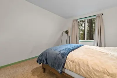 a white bedroom with a bed and a window at Midnight Pines Cabin - Cozy Get-Away Near Slopes! in Big Bear Lake
