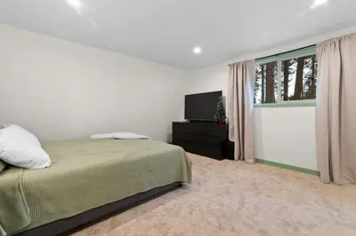 a bedroom with a bed and a flat screen tv at Midnight Pines Cabin - Cozy Get-Away Near Slopes! in Big Bear Lake