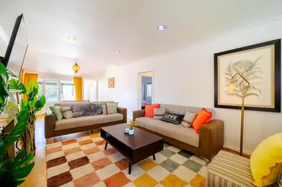 a living room with two couches and a coffee table at Pool Spa Games Peaceful Garden Retreat in Glendale