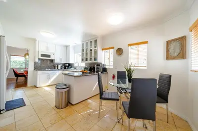 a kitchen and dining room with a table and chairs at Pool Spa Games Peaceful Garden Retreat in Glendale
