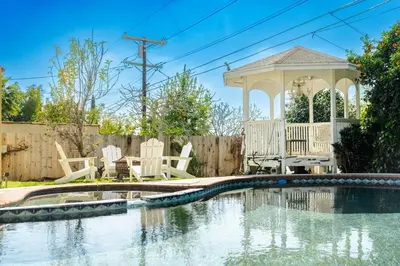 a swimming pool in a yard with a gazebo at Pool Spa Games Peaceful Garden Retreat in Glendale