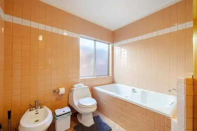 a bathroom with a toilet and a tub and a sink at Pool Spa Games Peaceful Garden Retreat in Glendale