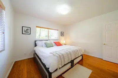 a bedroom with a bed with white sheets and a window at Pool Spa Games Peaceful Garden Retreat in Glendale