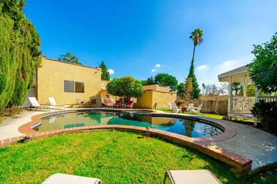 a swimming pool in the yard of a house at Pool Spa Games Peaceful Garden Retreat in Glendale