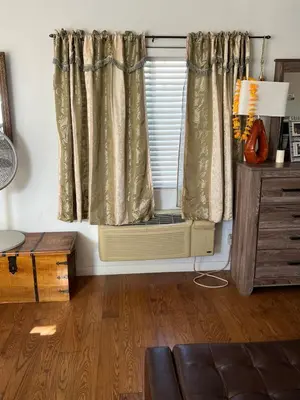 a room with a radiator and a window with curtains at B and G Studio Space Guesthouse in San Bernardino