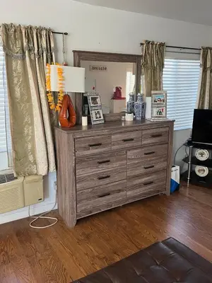 a large wooden dresser in a living room at B and G Studio Space Guesthouse in San Bernardino
