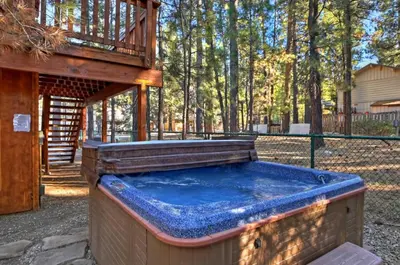 a large hot tub in a backyard with a deck at Big 10 Luxury Cabin/Walk to Snow Summit- HotTub in Big Bear Lake