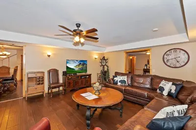 a living room with a couch and a table at Big 10 Luxury Cabin/Walk to Snow Summit- HotTub in Big Bear Lake