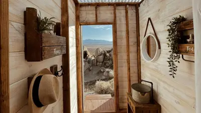 a door to a room with a view of the desert at Stunning Geo Dome with Joshua Tree vibes in Palmdale