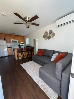 a living room with a couch and a ceiling fan at Mini-Home in Whittier in Whittier