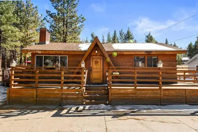 a house with a wooden fence in front of it at Lakeside Cottage, Charming 3-BDRM Retreat W Hottub in Big Bear Lake