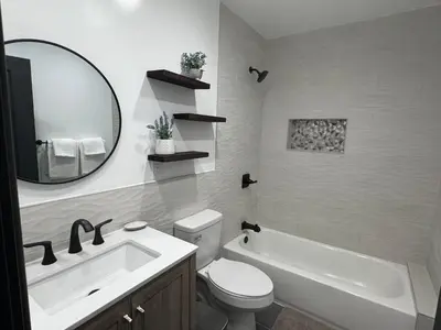 a bathroom with a sink and a toilet and a mirror at Modern Bedroom in Long Beach 1 in Long Beach