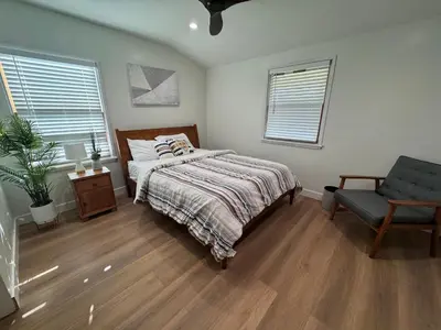 a bedroom with a bed and a chair at Modern Bedroom in Long Beach 1 in Long Beach