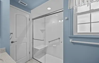 a bathroom with a shower with a glass door at Unique & Spacious house near Disney, Knott, BBQ in Buena Park