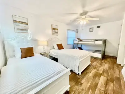a bedroom with two beds and a ceiling fan at Unique & Spacious house near Disney, Knott, BBQ in Buena Park