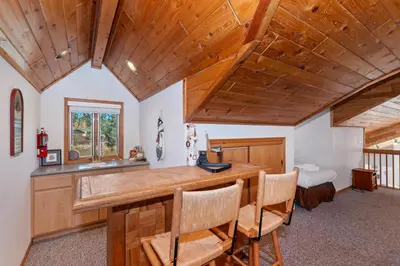 a kitchen with wooden ceilings and a table and chairs at Lakefront Estate with Views and Hot tub in Big Bear Lake