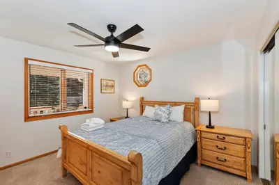 a bedroom with a bed and a ceiling fan at Lakefront Estate with Views and Hot tub in Big Bear Lake