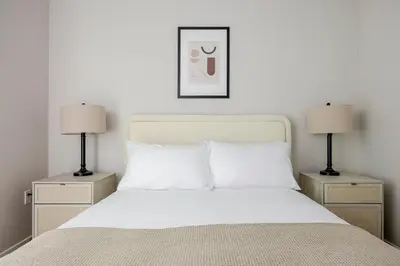 a bedroom with a white bed with two lamps at Blueground Downtown elevator nr parks LAX-1248 in Los Angeles