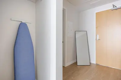 a room with a mirror and a blue surfboard on the wall at Blueground Downtown elevator nr parks LAX-1248 in Los Angeles