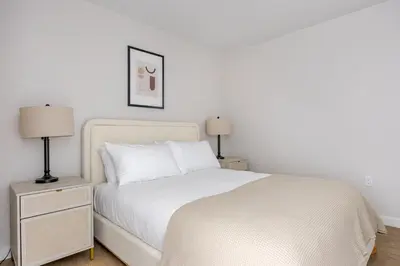 a bedroom with a white bed and two lamps at Blueground Downtown elevator nr parks LAX-1248 in Los Angeles