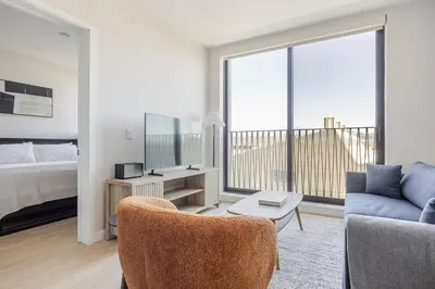 a living room with a bed a couch and a tv at Blueground Downtown elevator nr parks LAX-1250 in Los Angeles