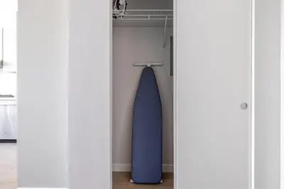 a blue surfboard is hanging in a closet at Blueground Downtown elevator nr parks LAX-1250 in Los Angeles